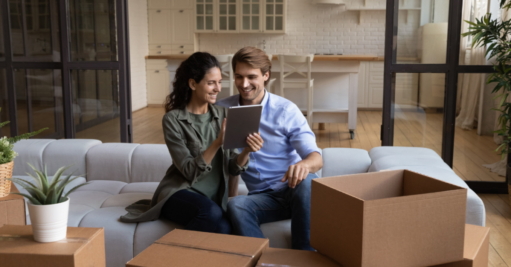 Happy couple looking at first-time buyer homeowners insurance