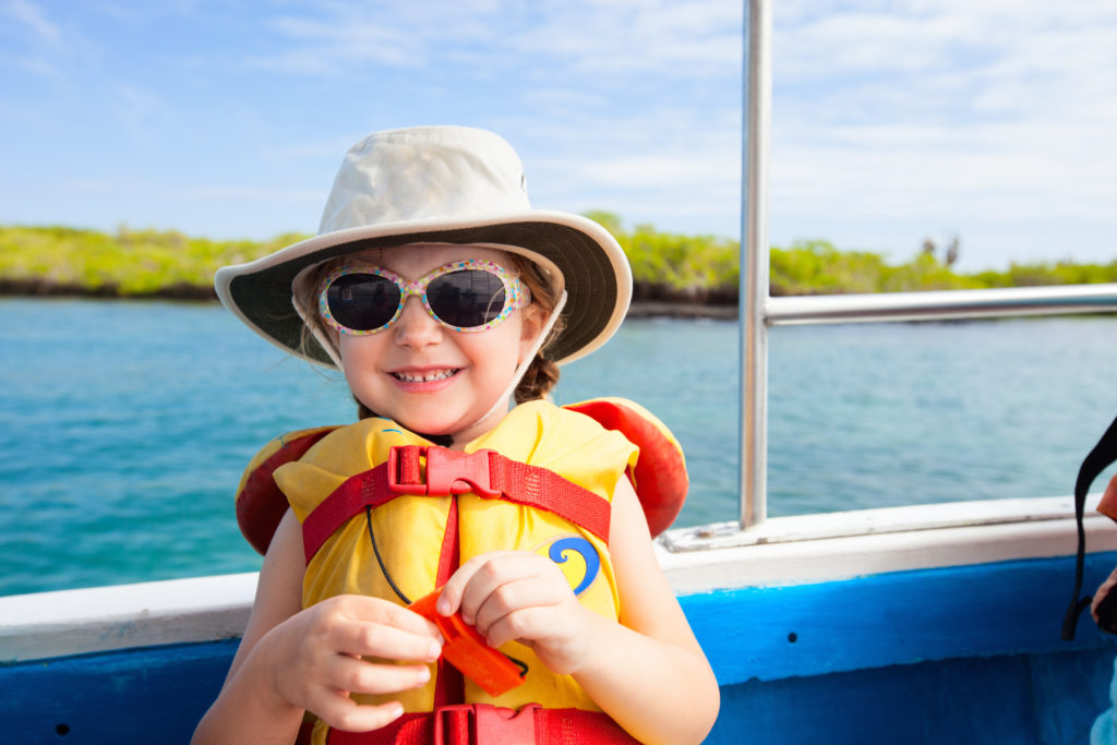 child on boat wearing a lifejacket