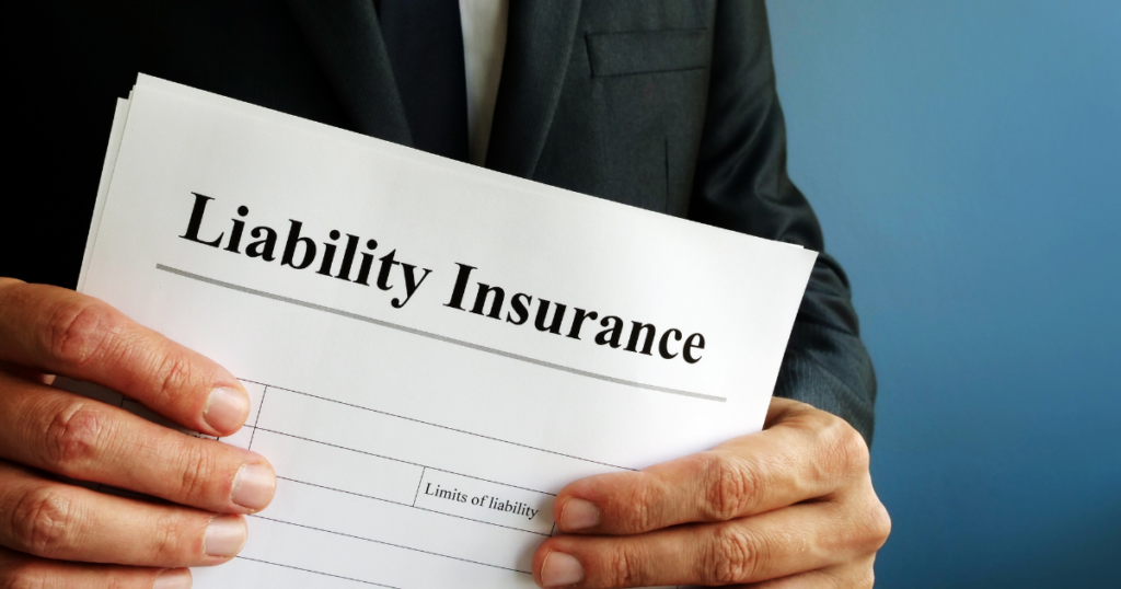 Businessman holding liability insurance document.