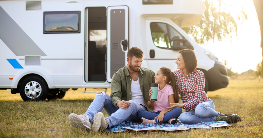 A family enjoying their travel lifestyle, sitting outside their RV