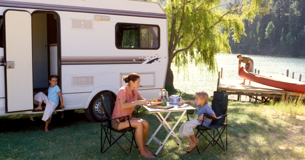 A carefree family is enjoying their vacation with their RV.