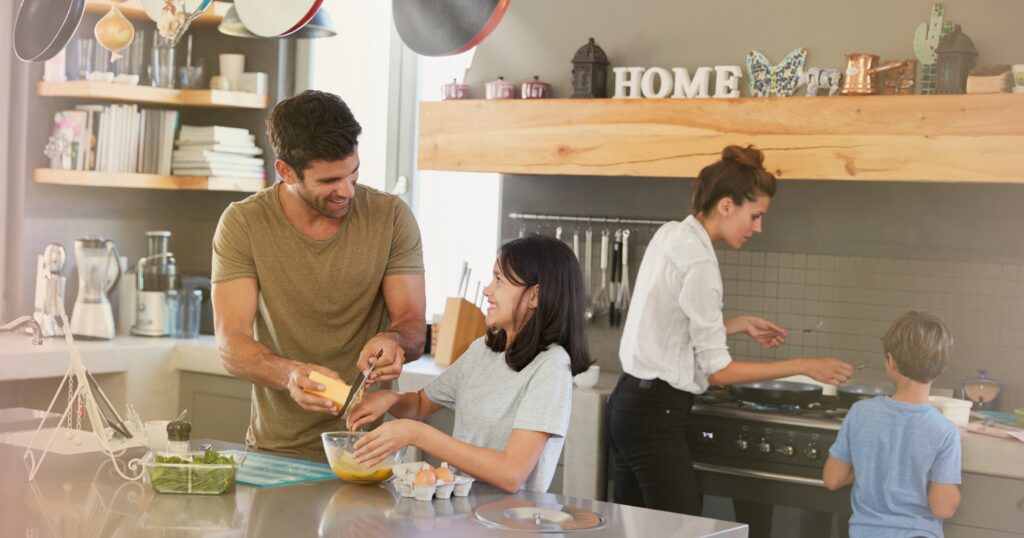Family cooking together at home, representing teamwork, planning, and starting new year 2026 with smart insurance resolutions and policy reviews.