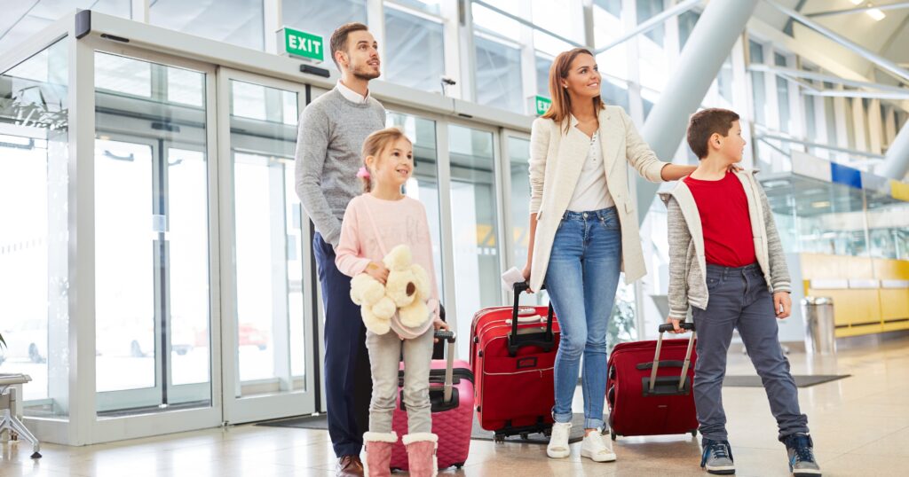 Family reviewing summer travel insurance plans before leaving for a vacation getaway.