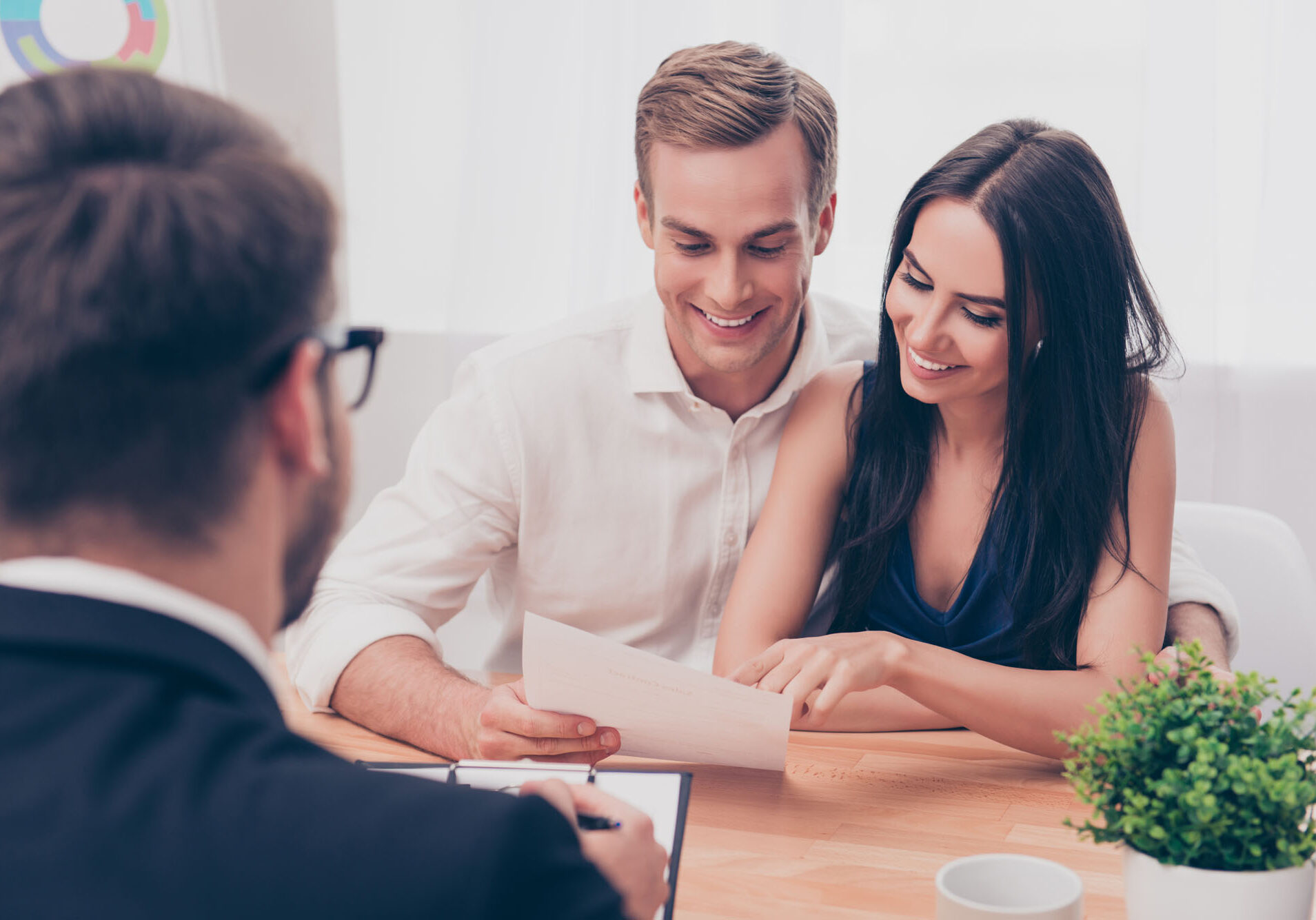 Successful lawyer giving consultation to family couple about buying house