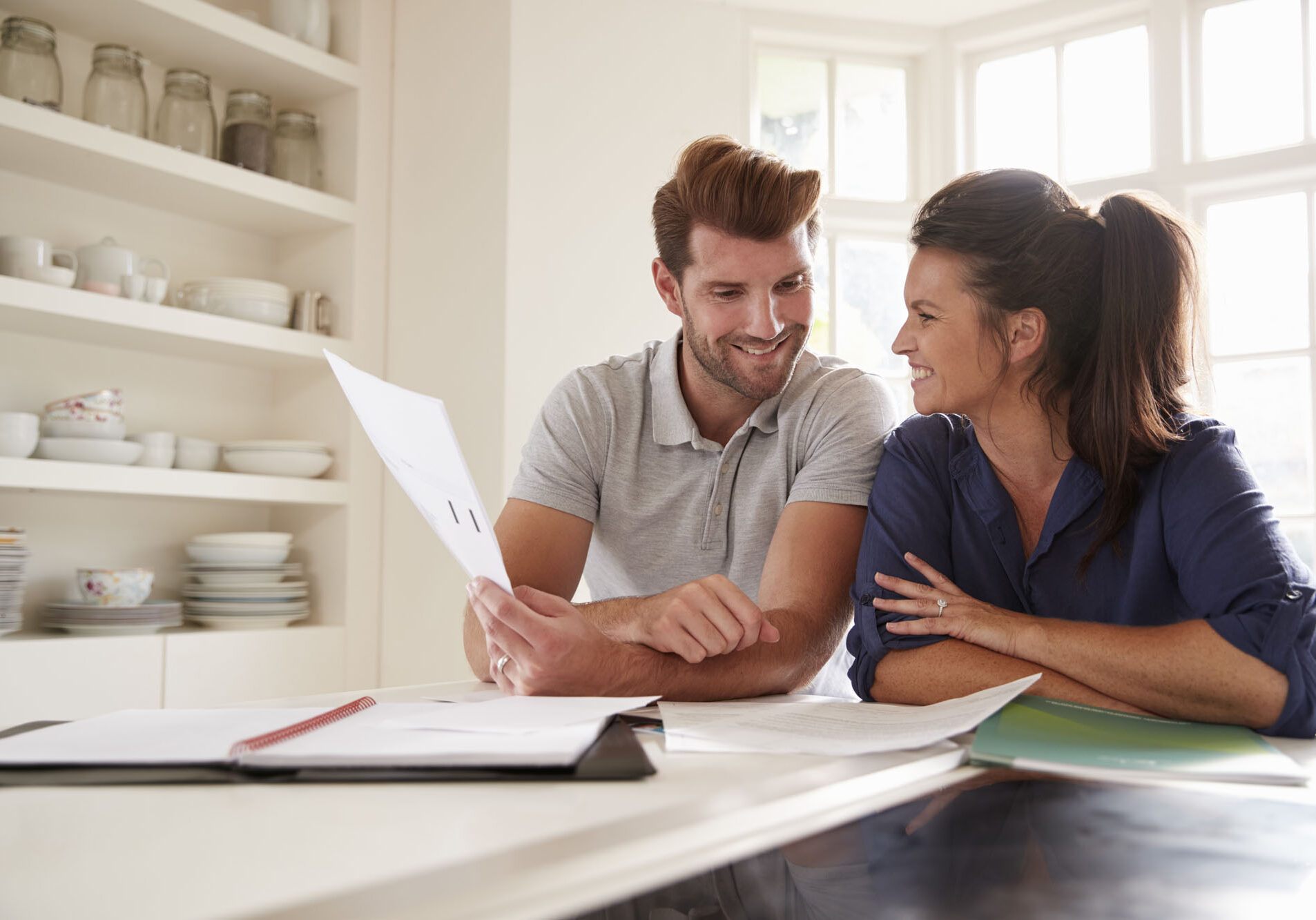 Couple Looking At Domestic Finances At Home Together